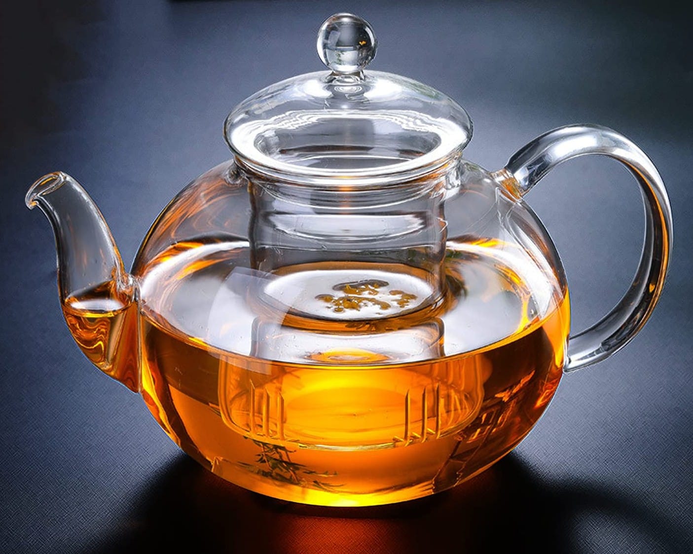 Teapot with infuser on a table